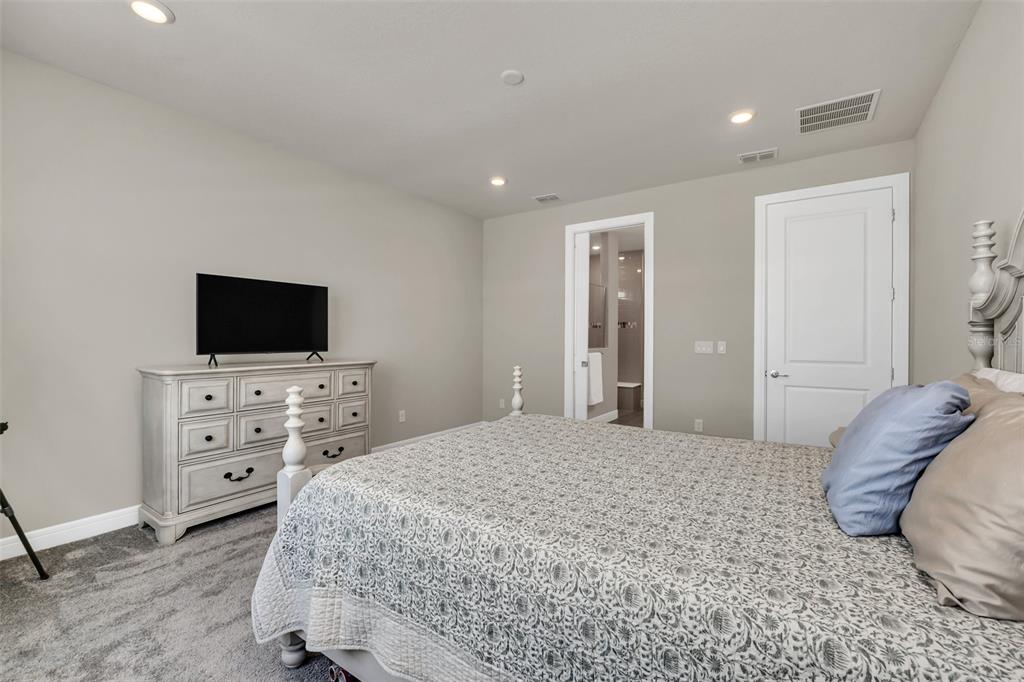 2001 Spring Shower Circle Kissimmee, FL 34744 - Photo 13 of 25 a bedroom with a bed and a flat screen tv