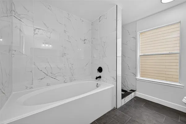 a bathroom with a bathtub and a shower