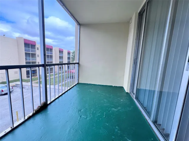 a view of a porch with wooden floor
