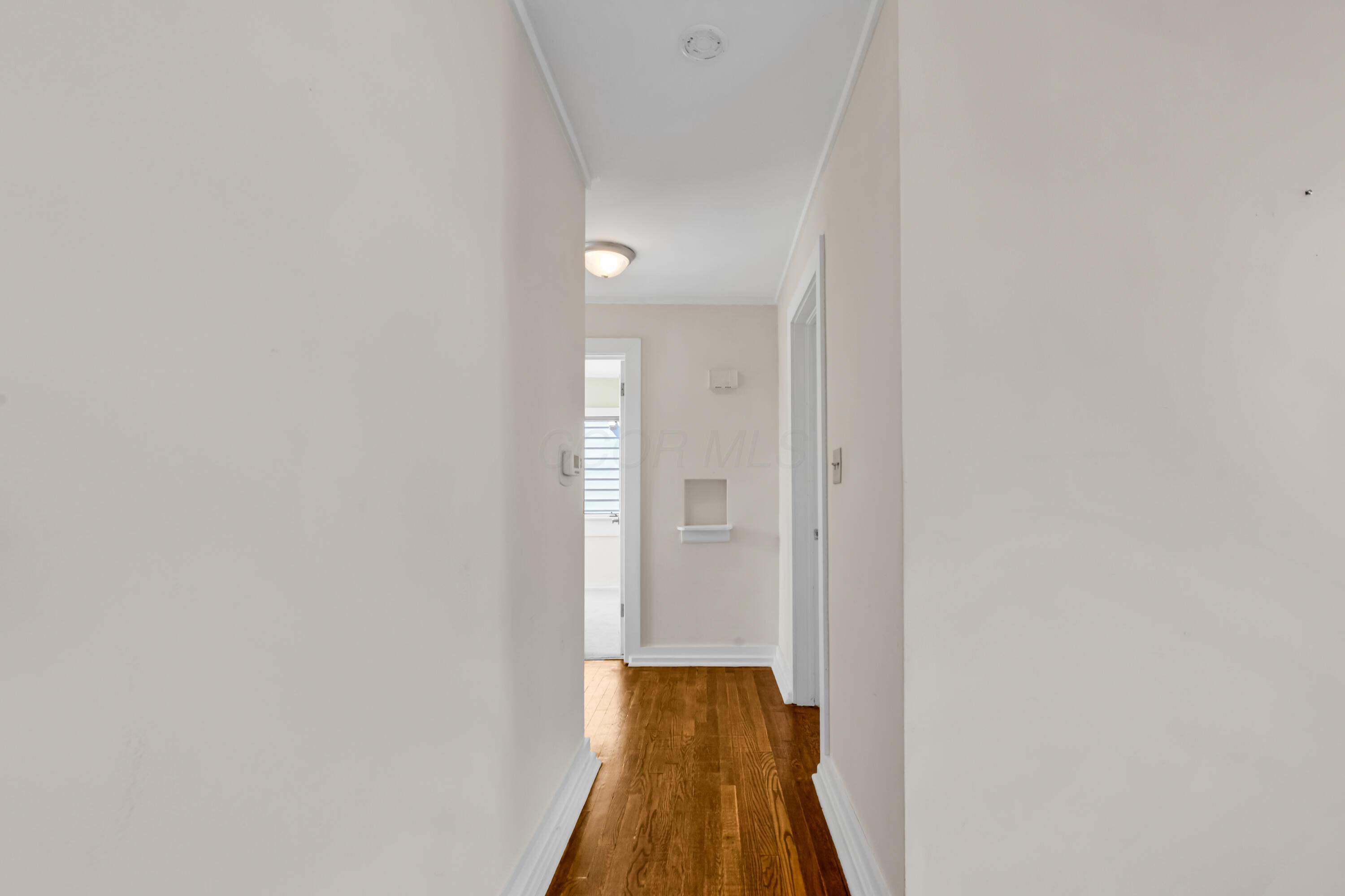 2033 Zollinger Road Columbus, OH 43221 - Photo 18 of 44 • Hardwood flooring
• Ivory painted walls
• Ceiling light
• Hall linen closet
• Recessed niche