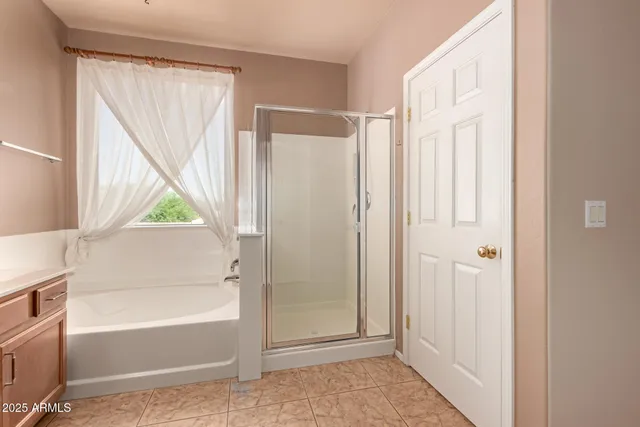 a bathroom with a bathtub and a shower