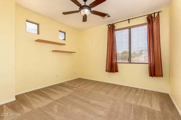 a view of room with a ceiling fan