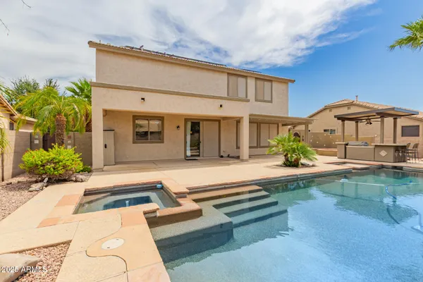 a view of a patio with swimming pool table and chairs
