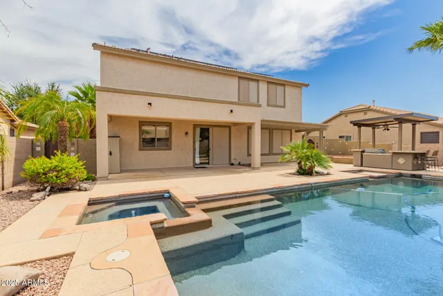 a view of a patio with swimming pool table and chairs
