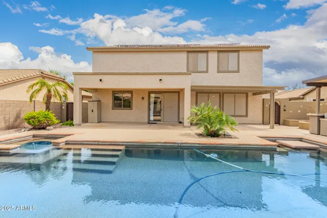 a view of a patio with table and chairs with wooden fence