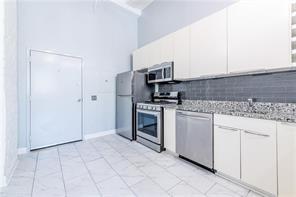 210 Walker Street Southwest, Unit 1 Atlanta, GA 30313 - Photo 19 of 37 a kitchen with a stove sink and a refrigerator