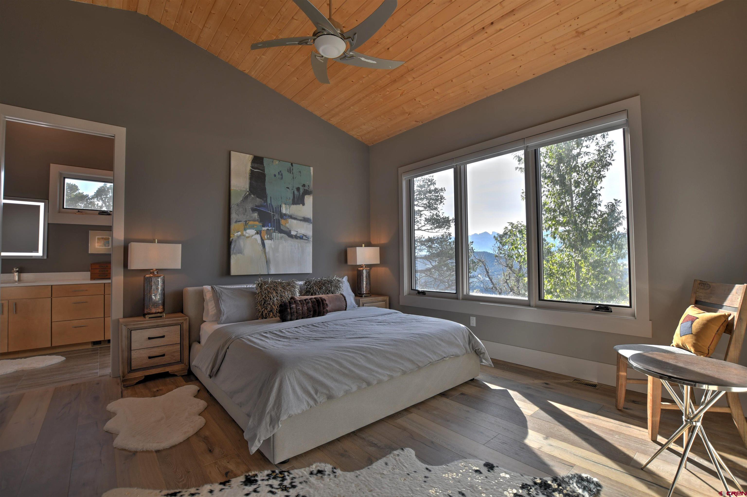 150 Enclave Road Ridgway, CO 81432 - Photo 12 of 45 a bedroom with a large bed and a couch