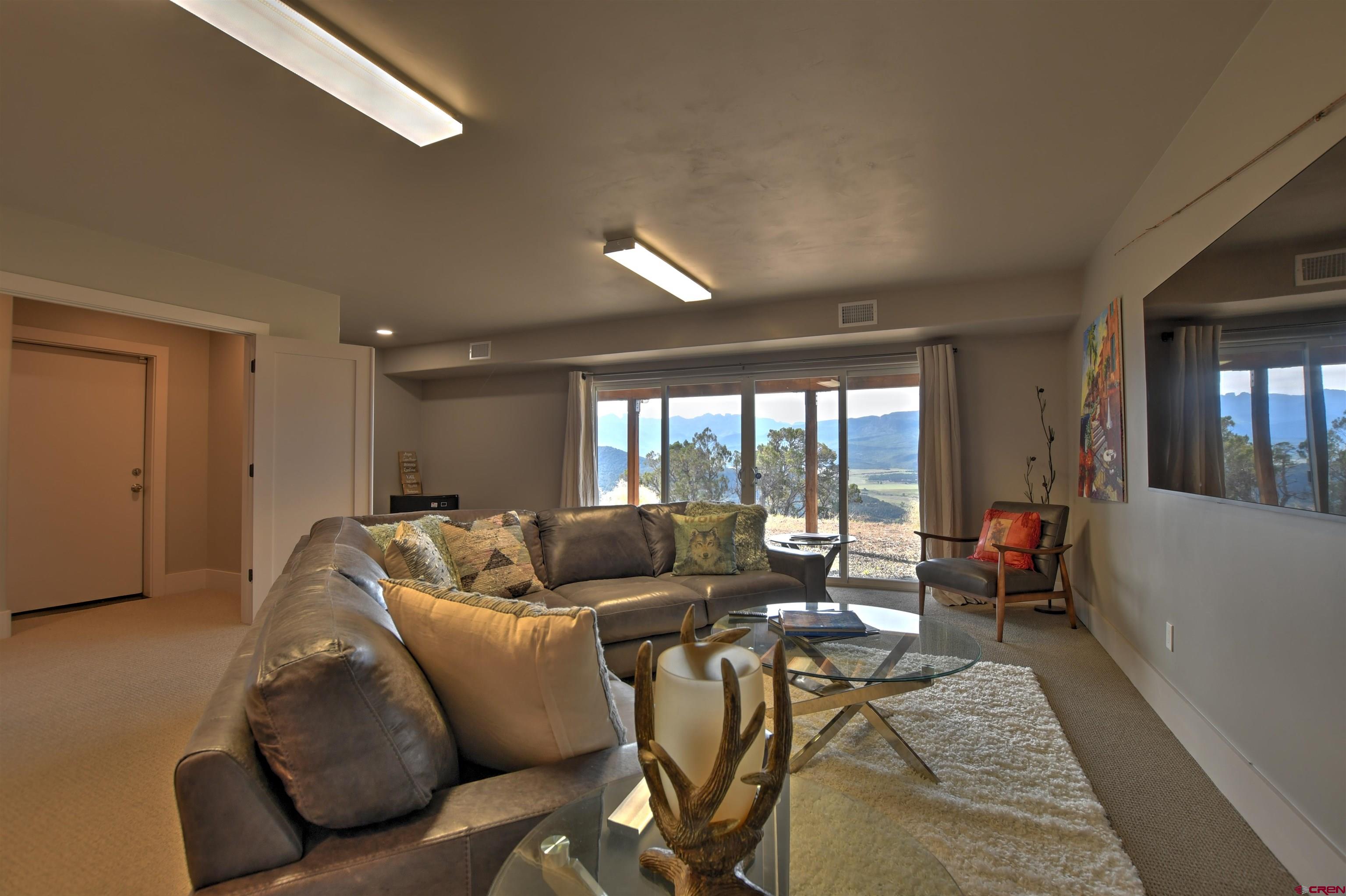 150 Enclave Road Ridgway, CO 81432 - Photo 18 of 45 a living room with furniture and a large window