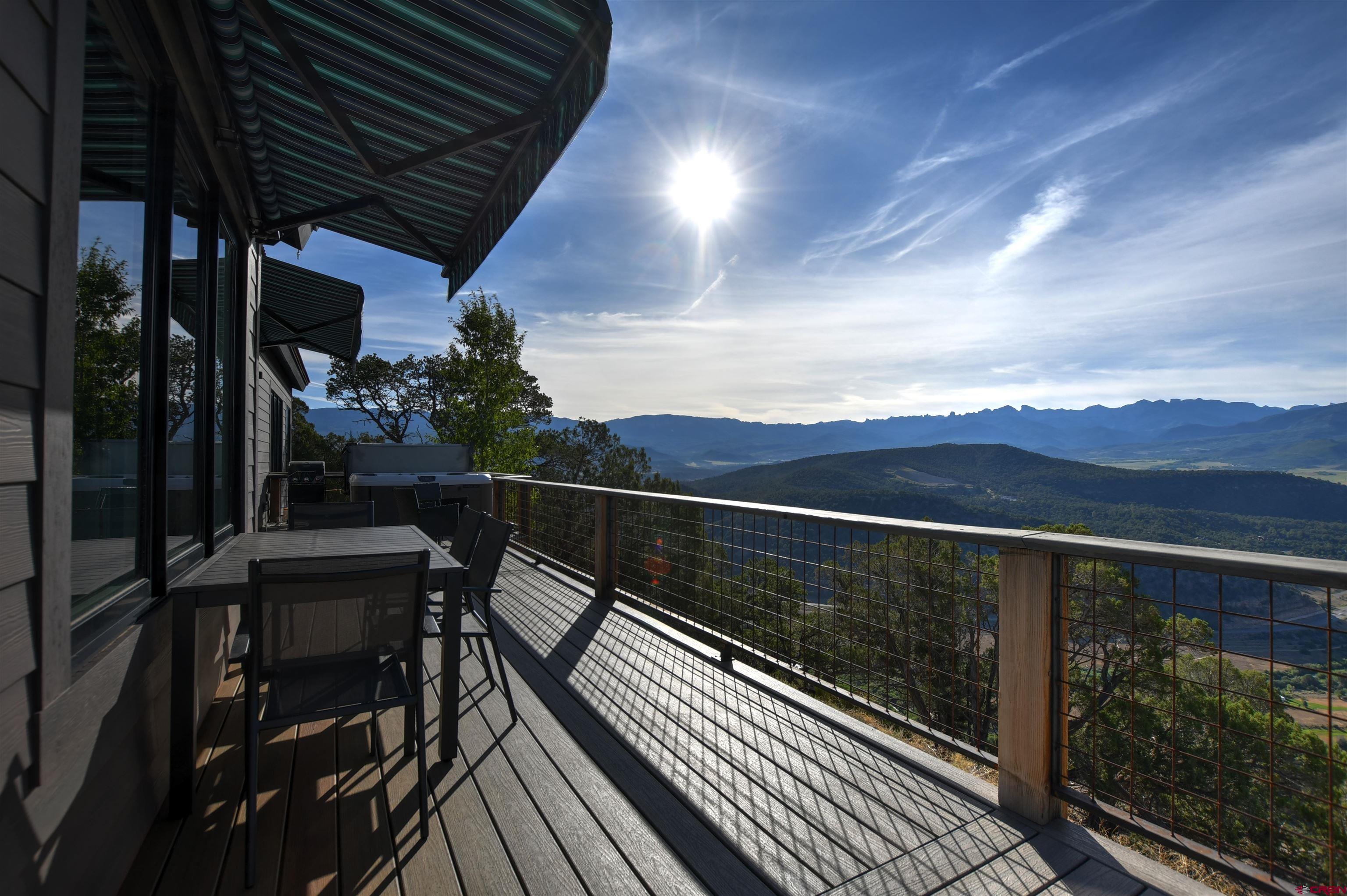150 Enclave Road Ridgway, CO 81432 - Photo 20 of 45 a view of balcony with chairs and wooden fence