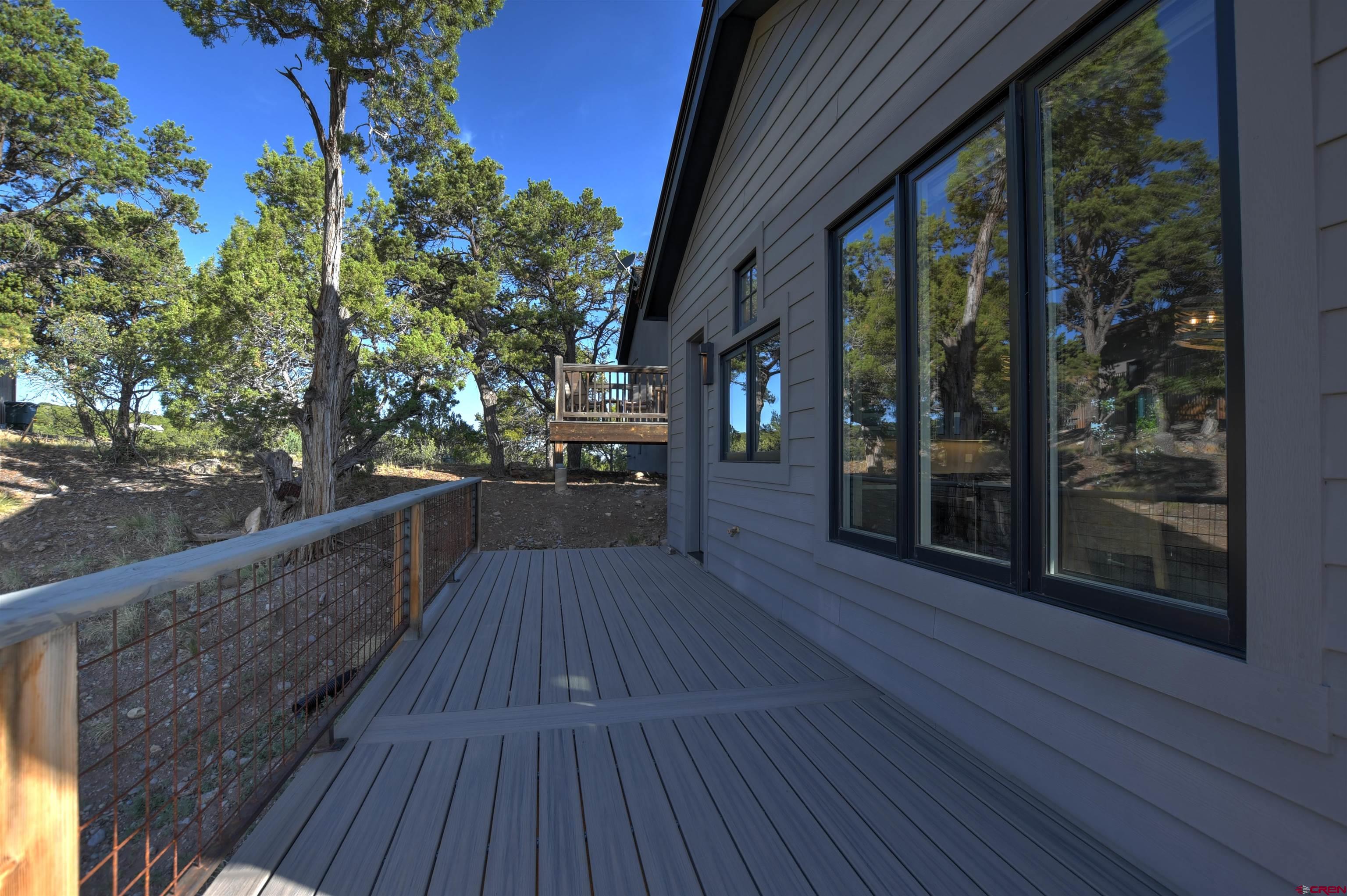 150 Enclave Road Ridgway, CO 81432 - Photo 22 of 45 a view of balcony with wooden floor and outdoor space