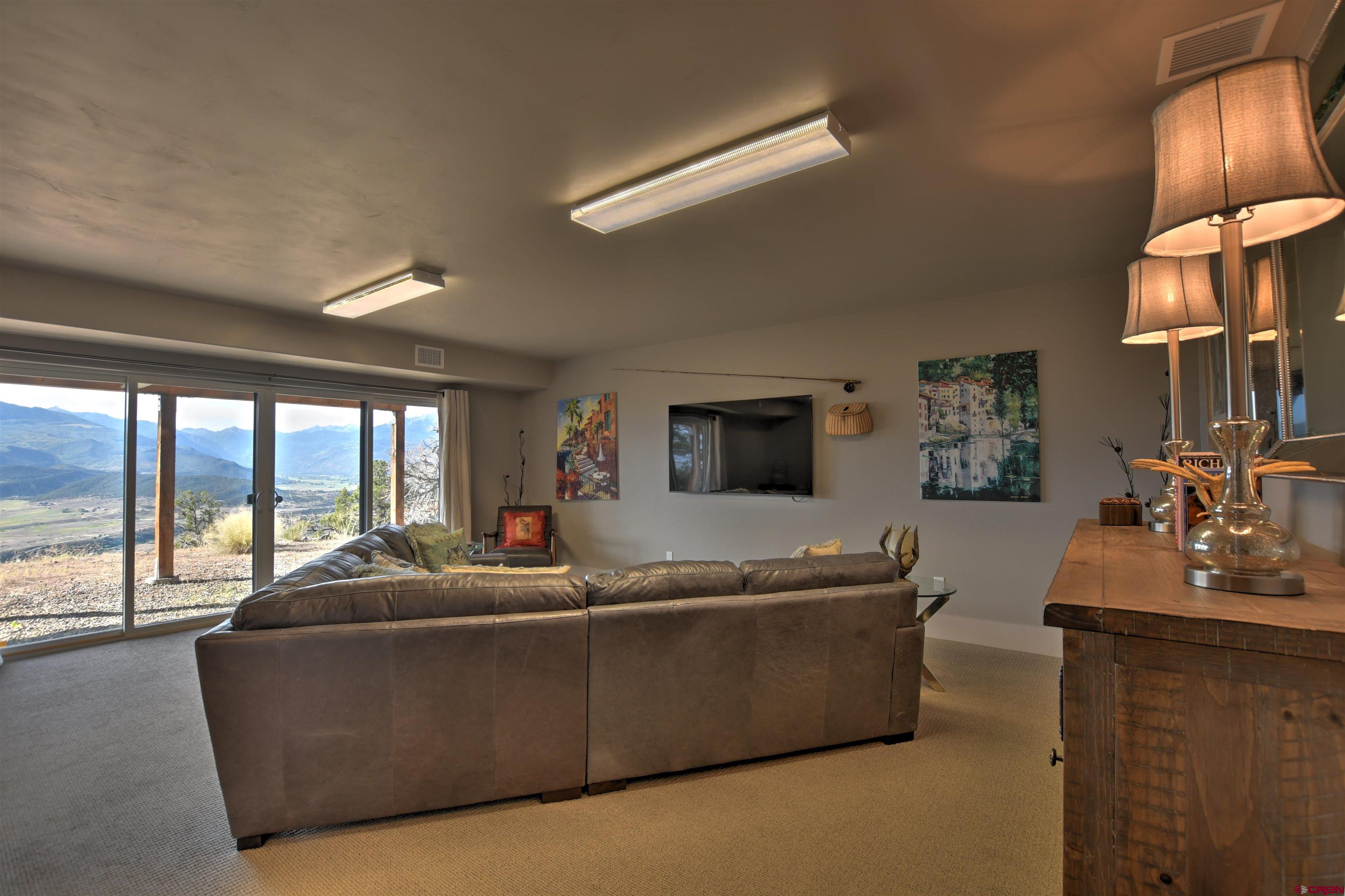150 Enclave Road Ridgway, CO 81432 - Photo 24 of 45 a living room with furniture and a flat screen tv