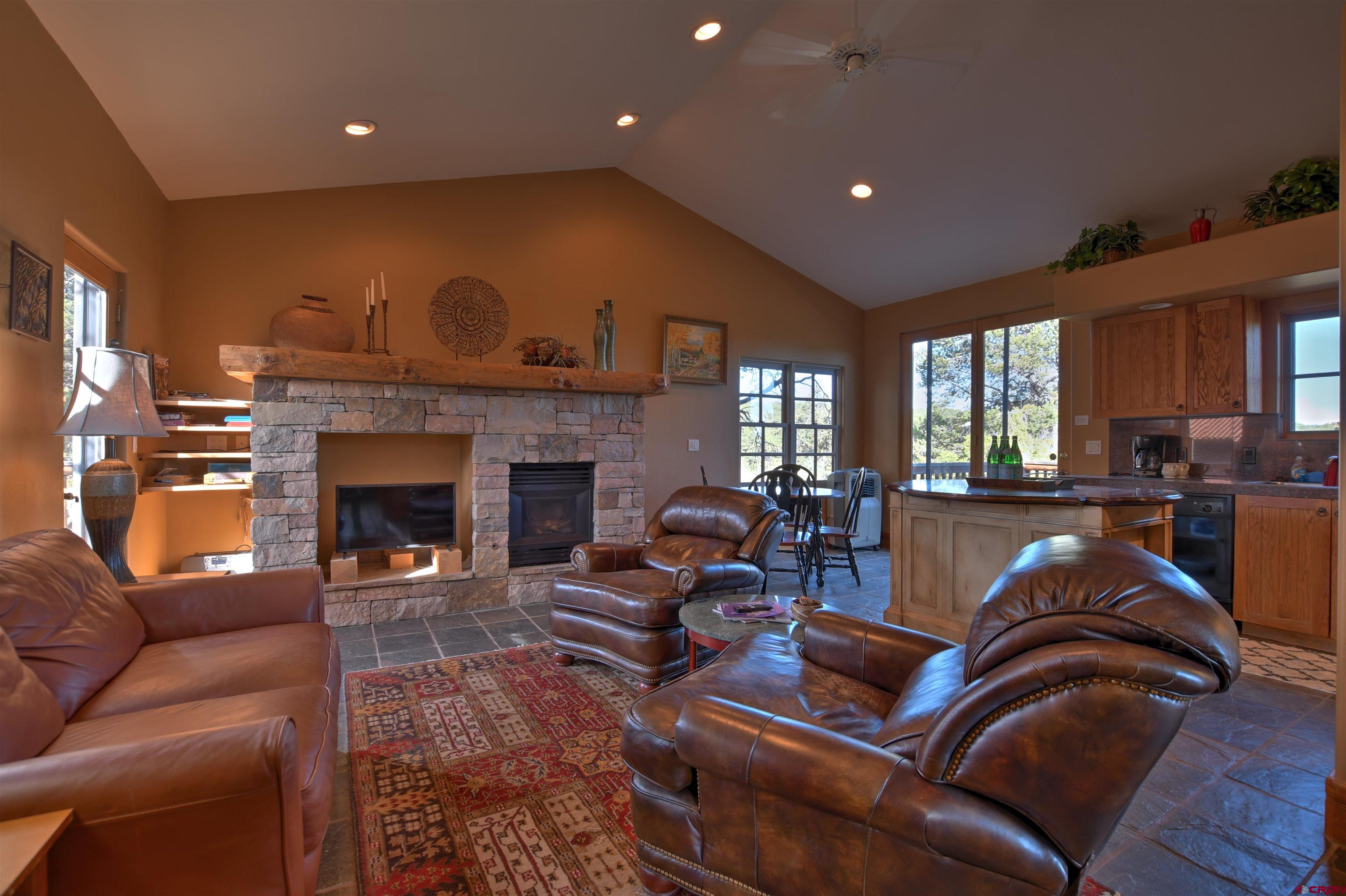 150 Enclave Road Ridgway, CO 81432 - Photo 25 of 45 a living room with furniture and a fireplace