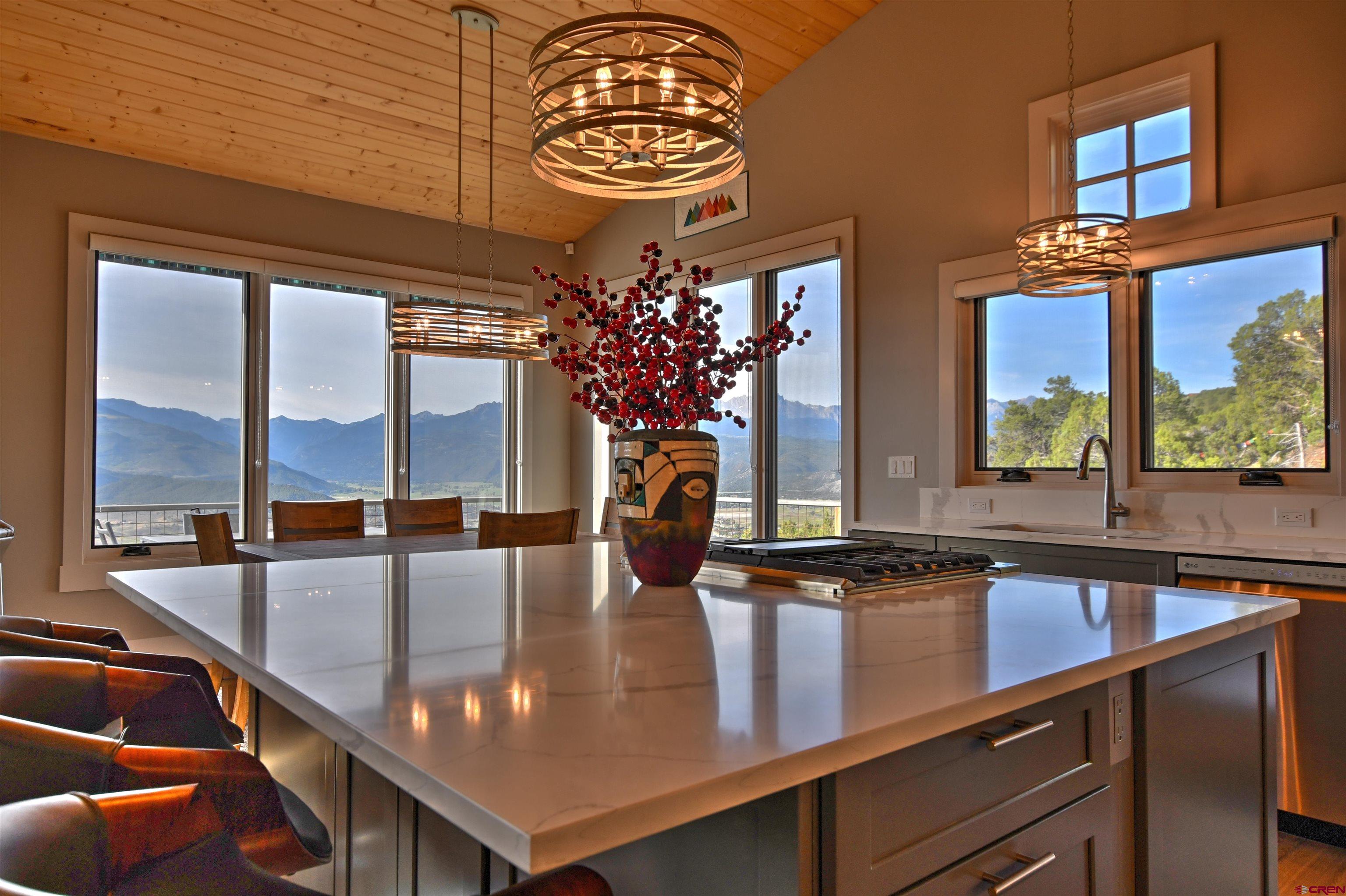 150 Enclave Road Ridgway, CO 81432 - Photo 3 of 45 a kitchen with a table chairs and chandelier