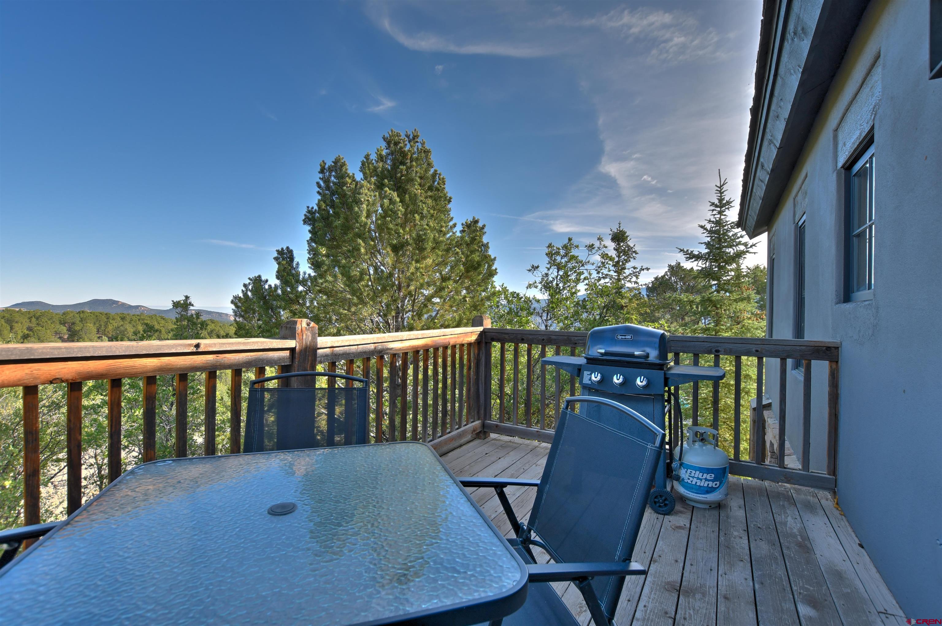 150 Enclave Road Ridgway, CO 81432 - Photo 32 of 45 a view of a balcony with wooden floor and outdoor seating