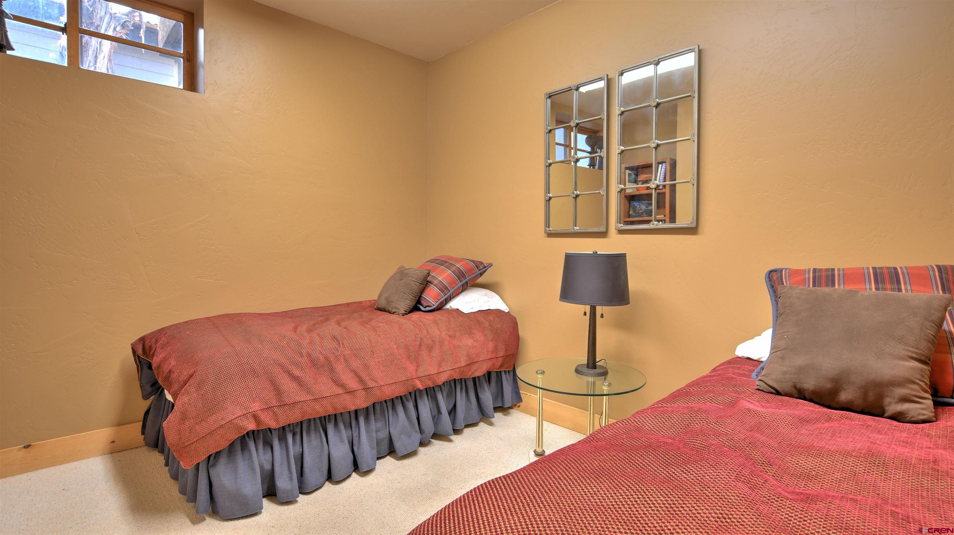 150 Enclave Road Ridgway, CO 81432 - Photo 34 of 45 a bedroom with bed and a lamp