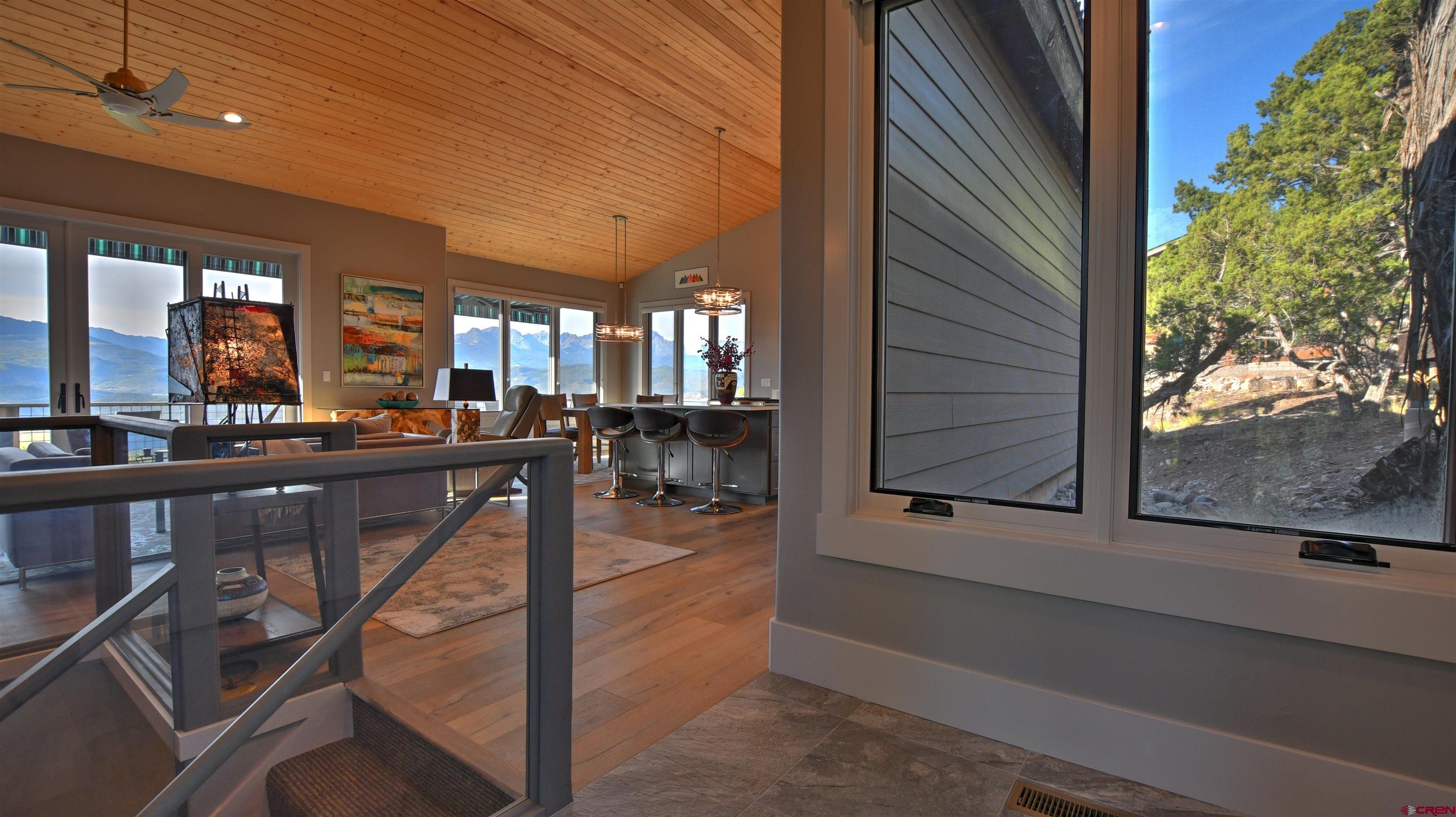 150 Enclave Road Ridgway, CO 81432 - Photo 38 of 45 a view of a porch with chairs and floor to ceiling window