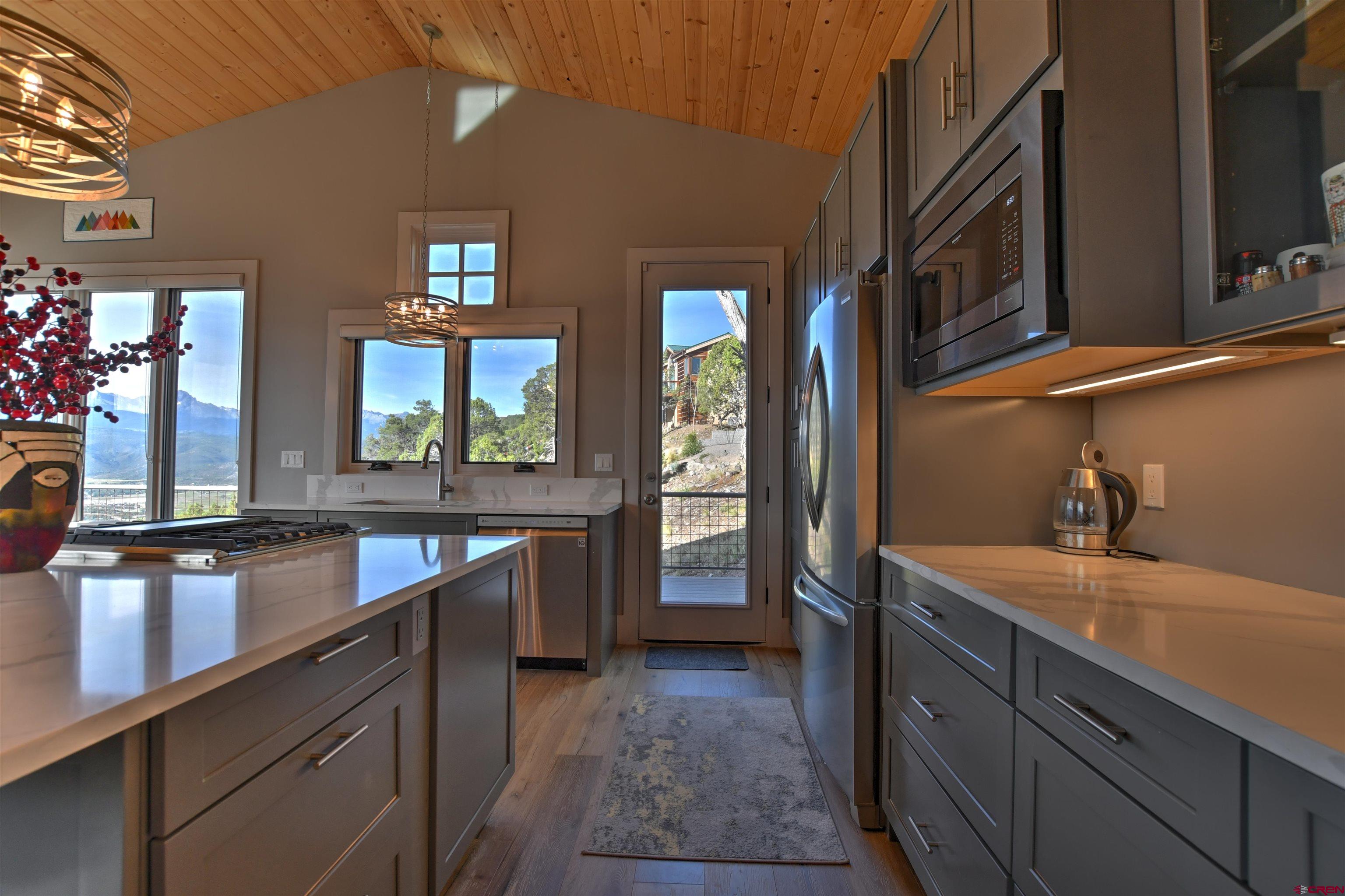 150 Enclave Road Ridgway, CO 81432 - Photo 4 of 45 a kitchen with a sink stove and refrigerator