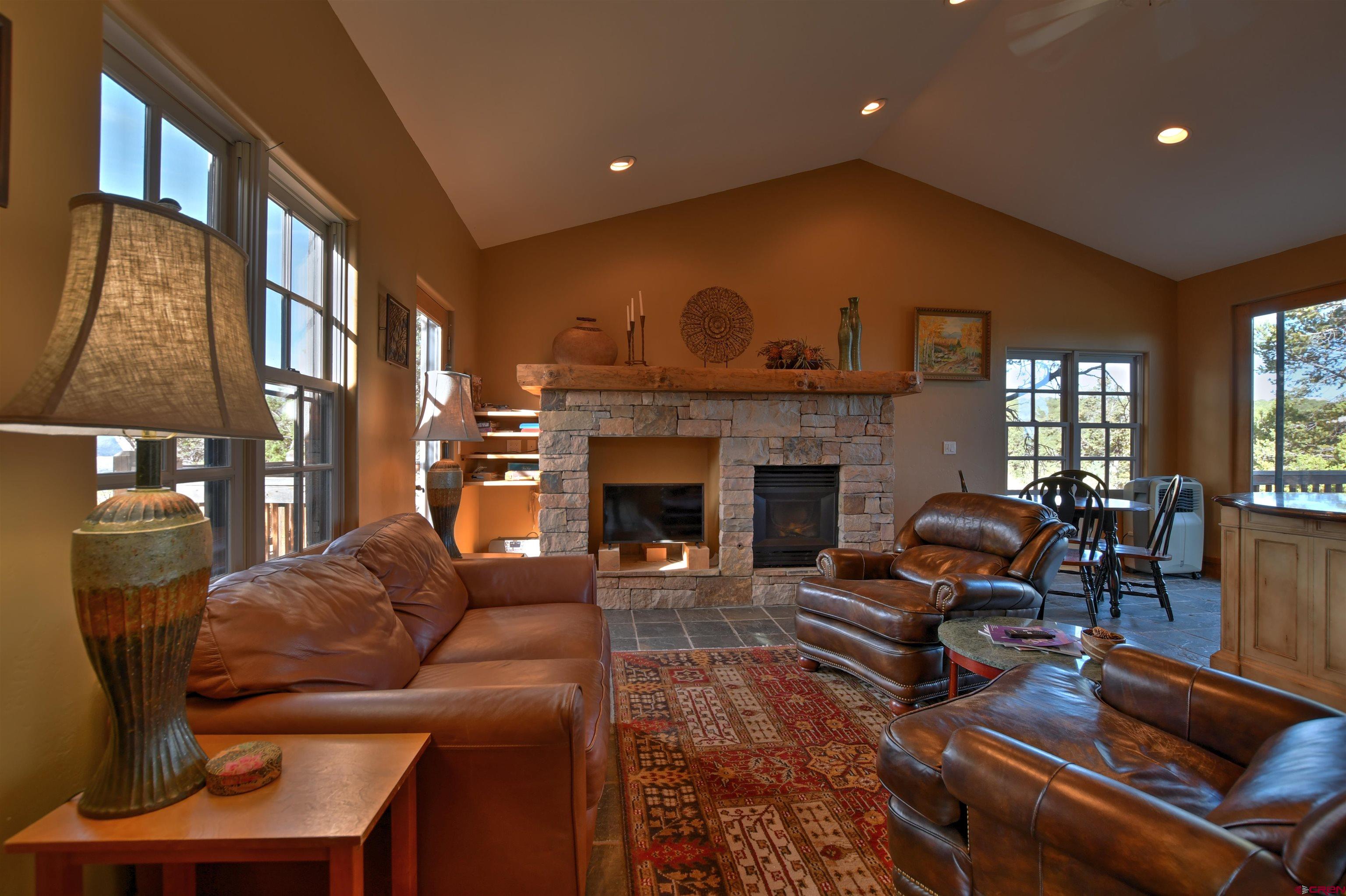 150 Enclave Road Ridgway, CO 81432 - Photo 45 of 45 a living room with furniture fireplace and a table