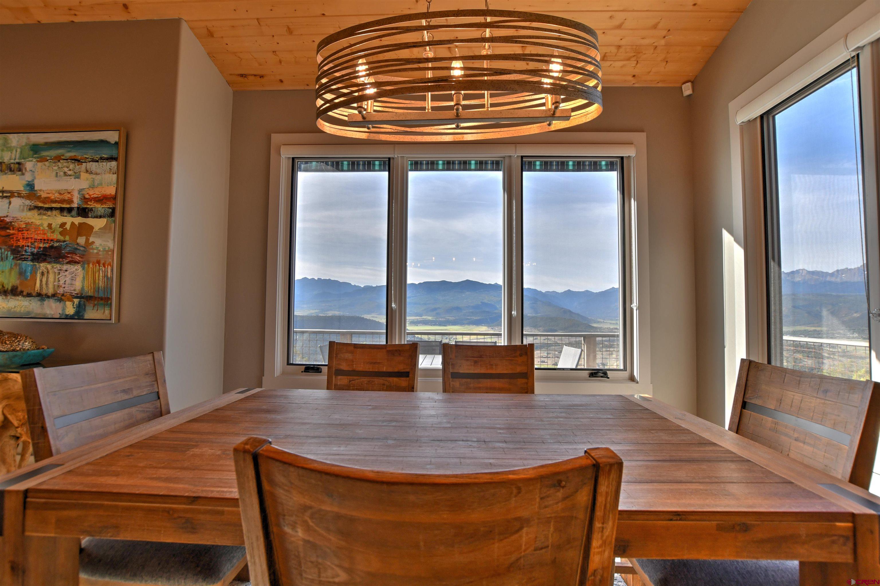 150 Enclave Road Ridgway, CO 81432 - Photo 6 of 45 a dining room with furniture window and wooden floor