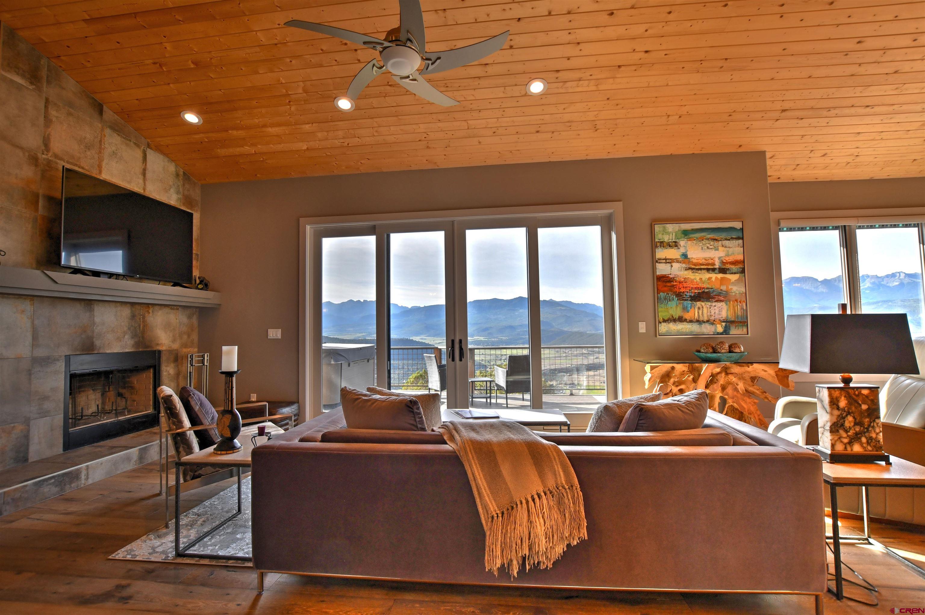 150 Enclave Road Ridgway, CO 81432 - Photo 10 of 45 a living room with fireplace furniture and a flat screen tv