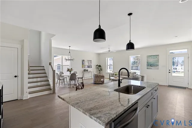 a kitchen with stainless steel appliances granite countertop a sink a oven and dining table