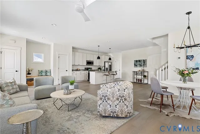 a living room with furniture and a dining table with kitchen view