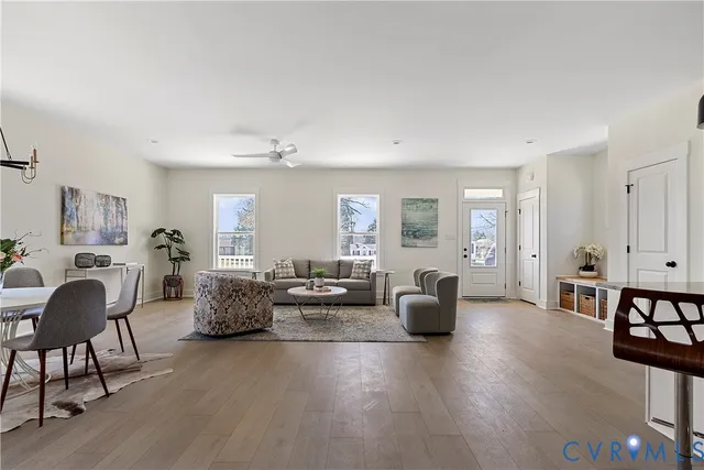 a living room with furniture and wooden floor