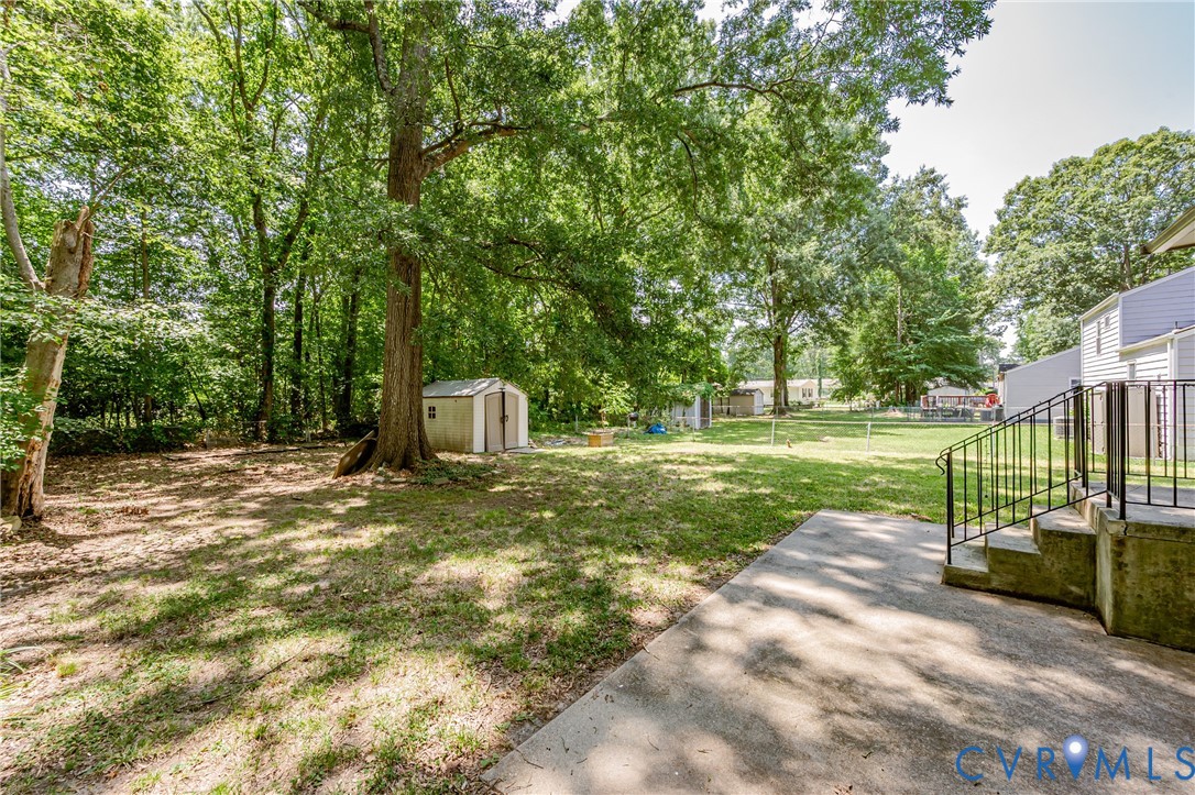 709 Deter Road Richmond, VA 23225 - Photo 33 of 38 Expansive backyard featuring mature trees, a stora
