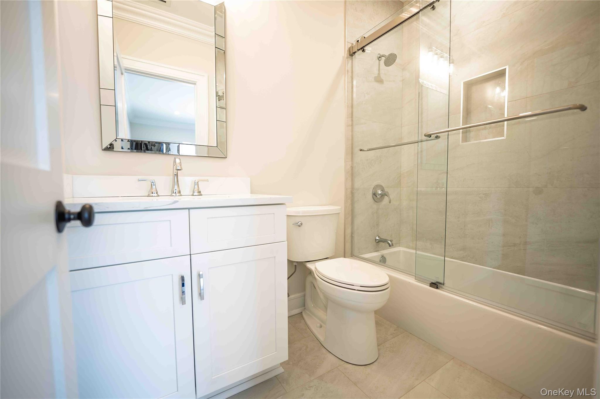 106 Cove Road Asharoken, NY 11768 - Photo 33 of 46 Full bath with vanity, shower / bath combination with glass door, and light tile patterned flooring