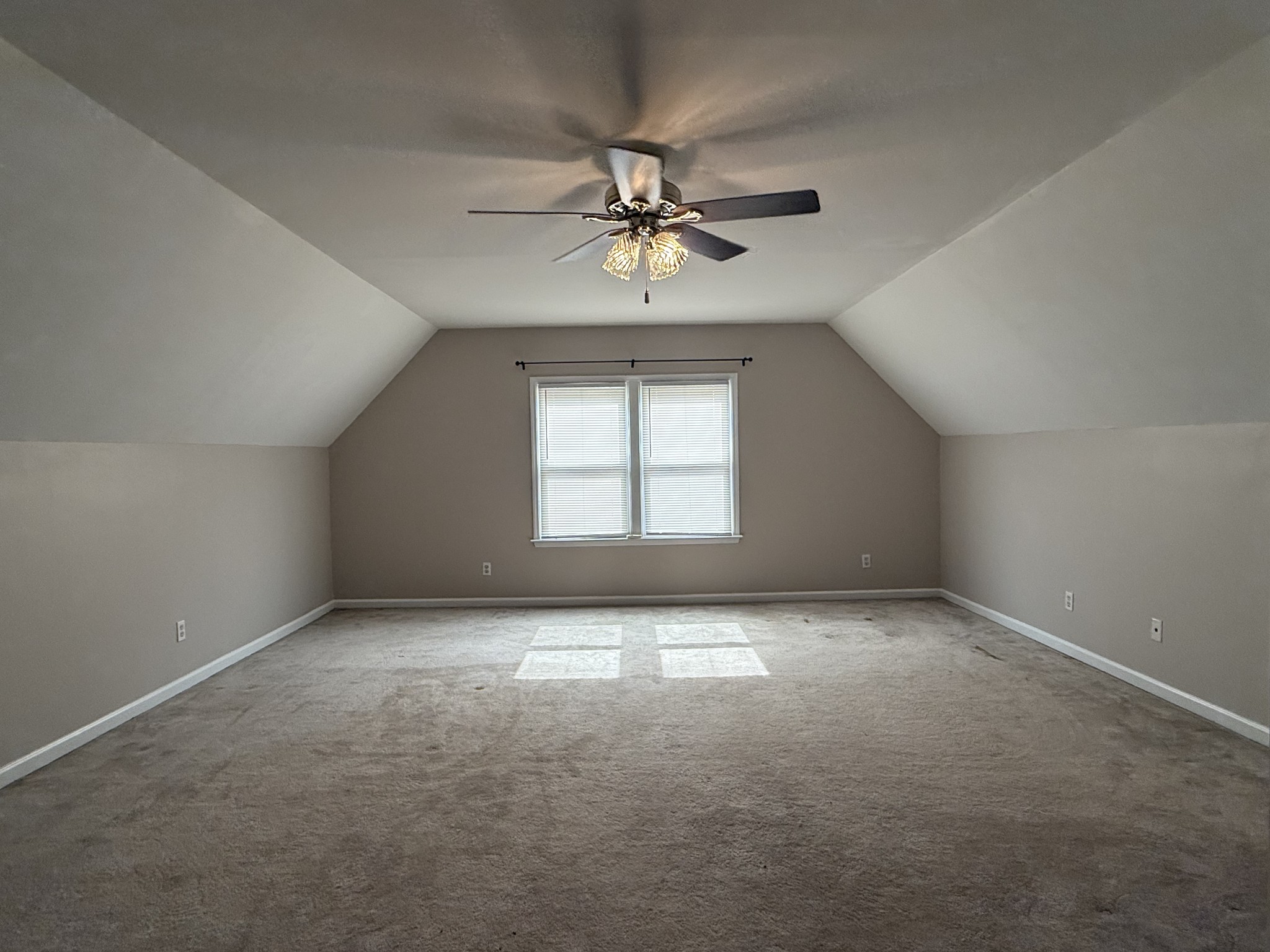 135 Lake Pointe Road La Vergne, TN 37086 - Photo 12 of 14 an empty room with a chandelier fan and windows