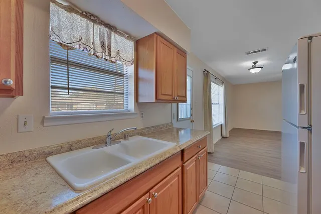 a kitchen with granite countertop a sink cabinets and window