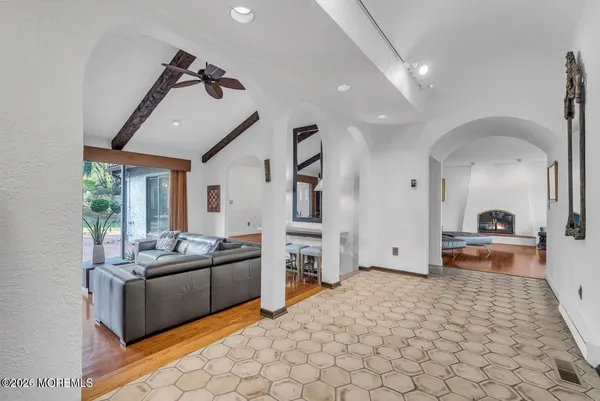a living room with furniture a fireplace and a large window