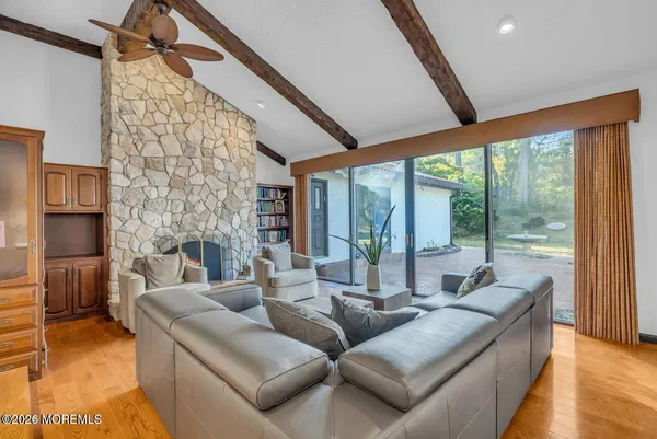 a dining room with furniture a chandelier and wooden floor