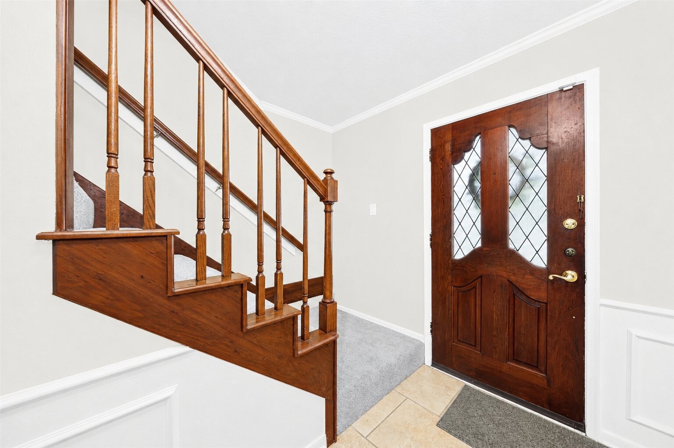 6507 Spring Leaf Drive Spring, TX 77379 - Photo 2 of 50 Step into a warm and welcoming entryway featuring a beautifully crafted solid wood front door with decorative glass that lets in natural light.