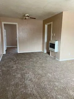 an empty room with a bench and mirror