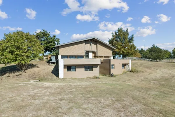 a white house that has a tree in front of it