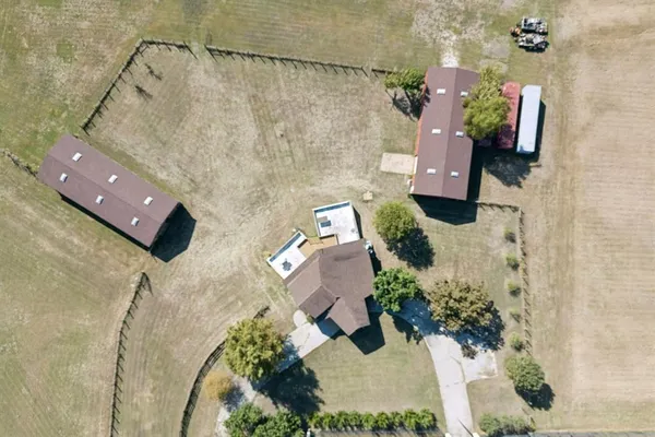 an aerial view of a house with a yard and fountain