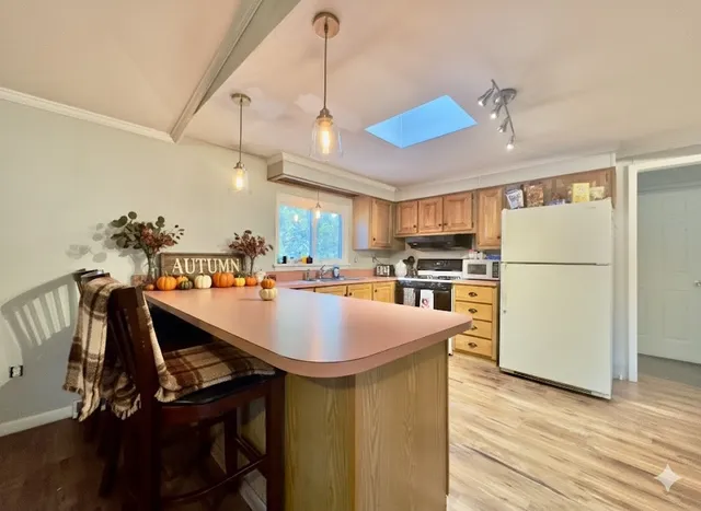 a kitchen with kitchen island a sink a counter space and stainless steel appliances