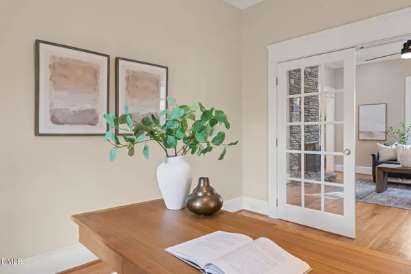 a view of a livingroom with wooden floor and a potted plant