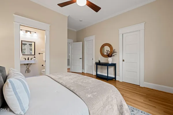 a spacious bedroom with a bed and a chandelier