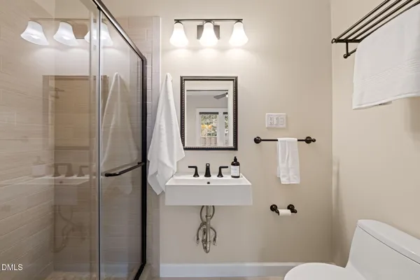 a bathroom with a sink toilet and shower