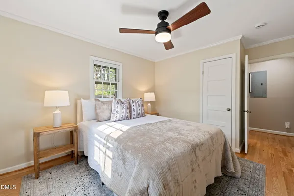 a bedroom with a bed and a lamp