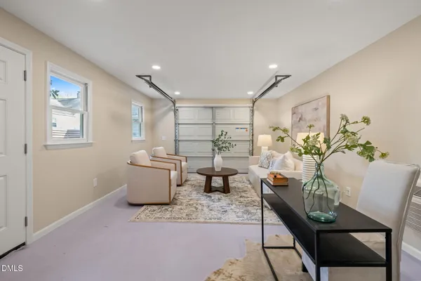 an empty room with wooden floor and a bathroom