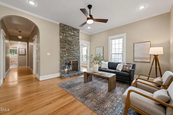 a living room with furniture and wooden floor
