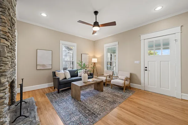 a living room with furniture and wooden floor