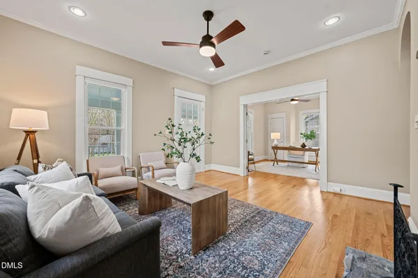 a living room with furniture potted plant and a large window