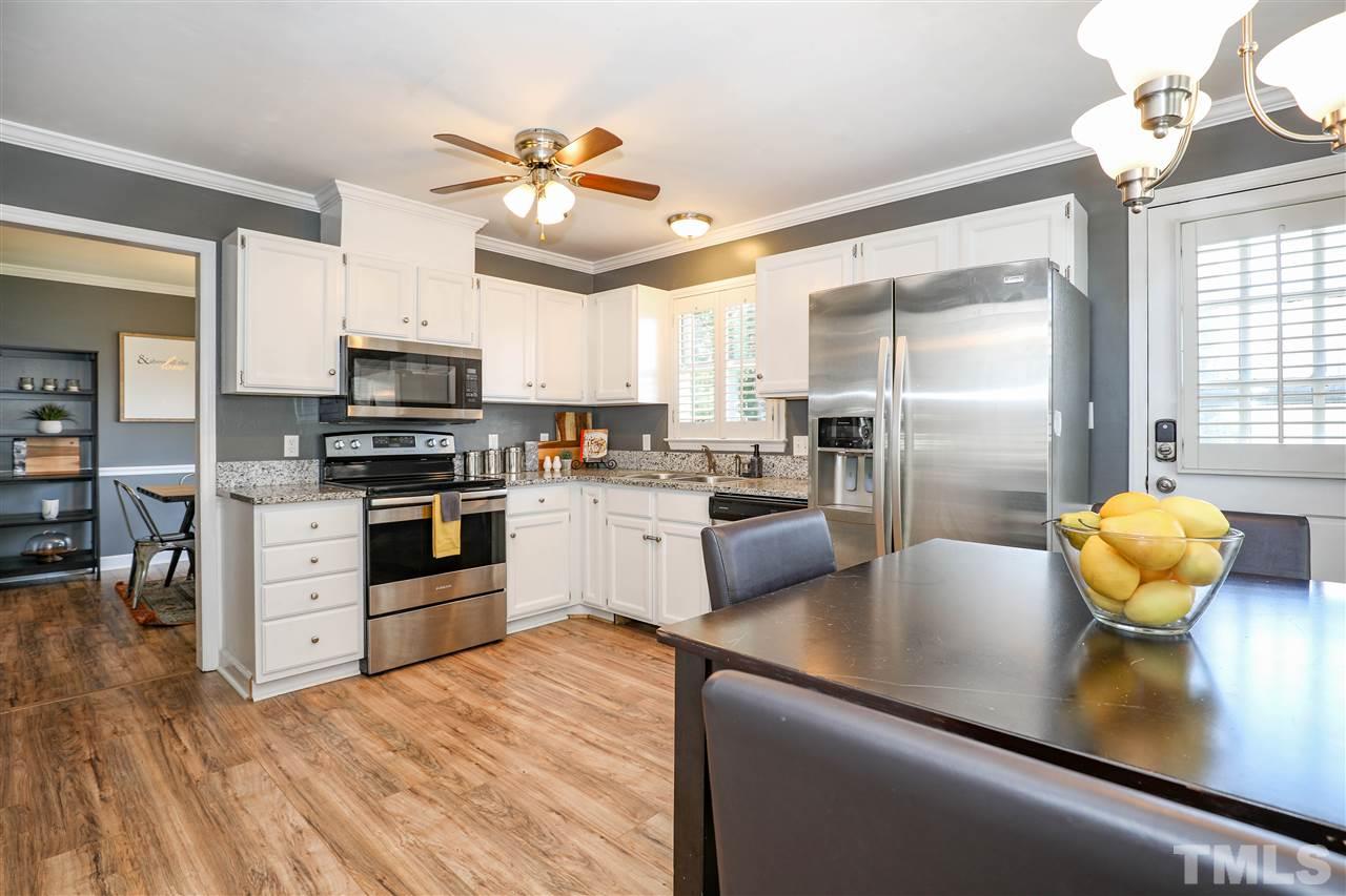 4841 Draper Road Raleigh, NC 27616 - Photo 12 of 30 a kitchen with stainless steel appliances a sink a stove and refrigerator