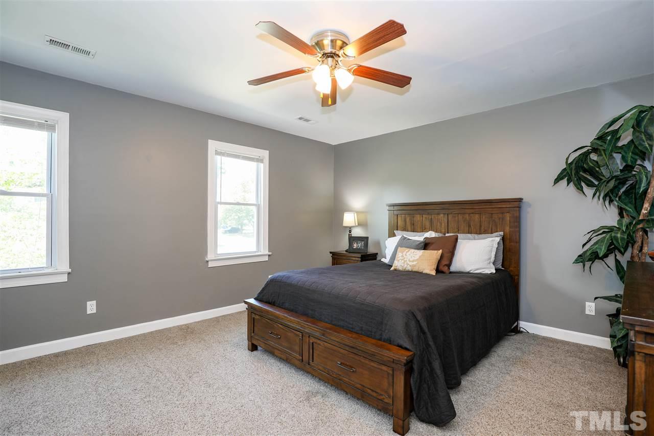 4841 Draper Road Raleigh, NC 27616 - Photo 15 of 30 a bedroom with a bed and a potted plant