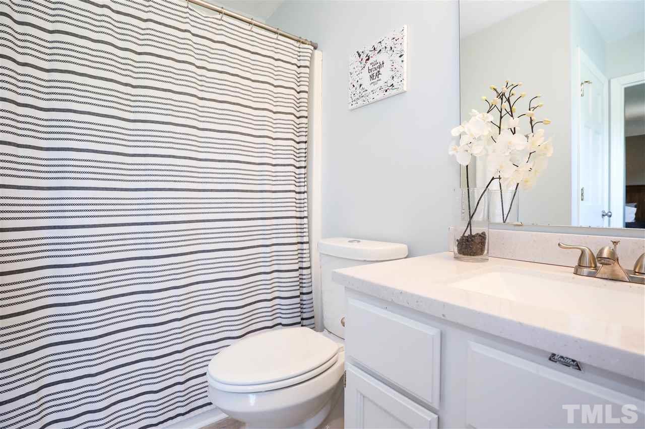 4841 Draper Road Raleigh, NC 27616 - Photo 17 of 30 a bathroom with a toilet a sink and mirror