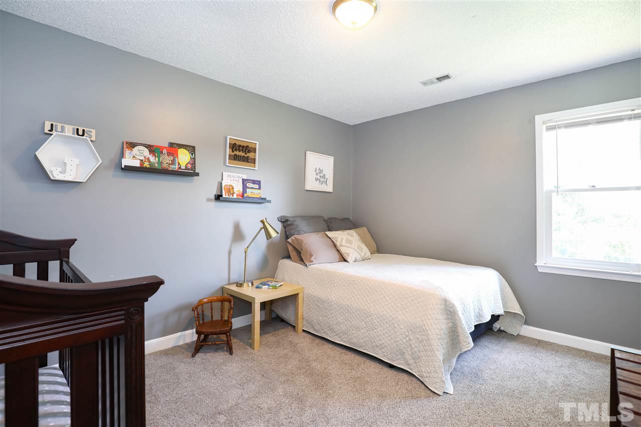 4841 Draper Road Raleigh, NC 27616 - Photo 19 of 30 a bedroom with a bed and a window